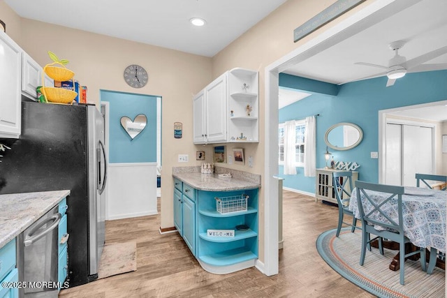 kitchen with light wood-style flooring, appliances with stainless steel finishes, white cabinets, and open shelves