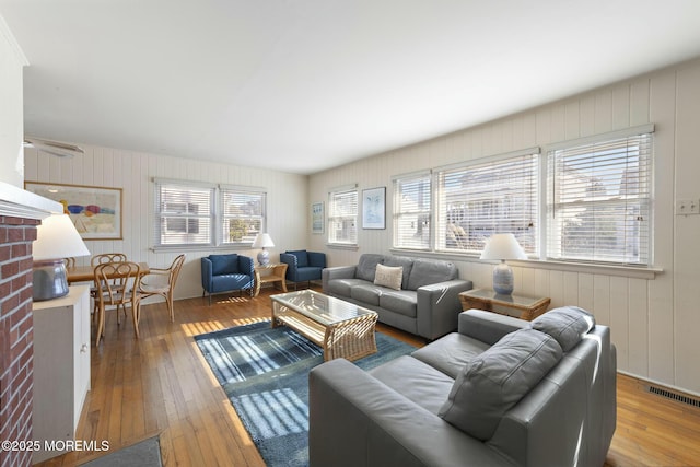 living area featuring hardwood / wood-style flooring and visible vents