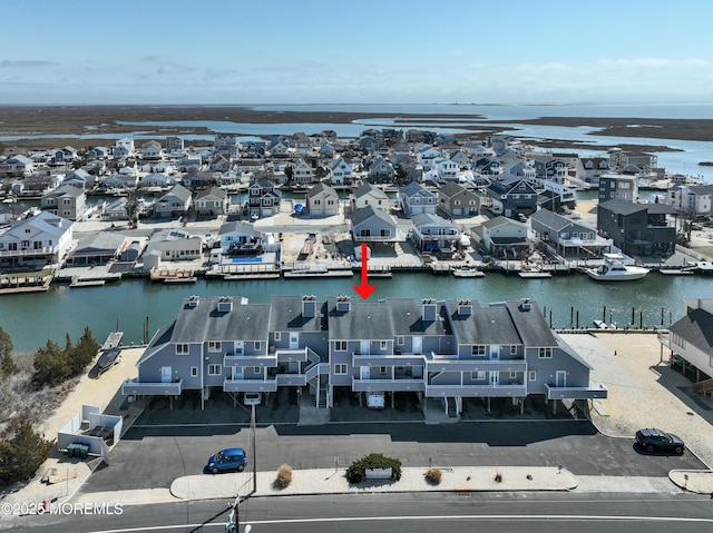 birds eye view of property with a residential view and a water view