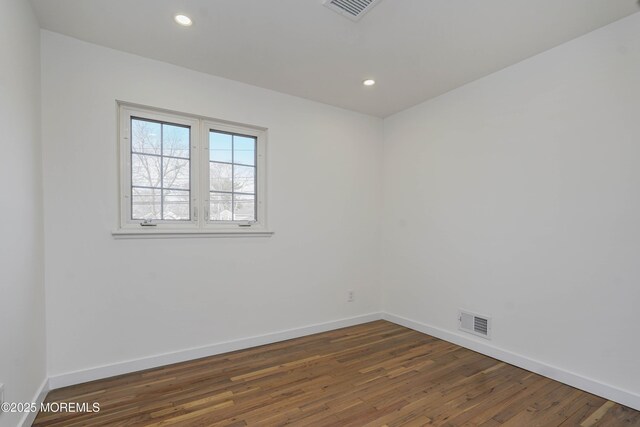 empty room with visible vents, recessed lighting, baseboards, and dark wood-style flooring