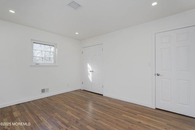 unfurnished room featuring recessed lighting, visible vents, baseboards, and wood finished floors