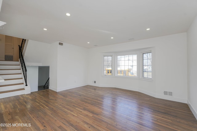 unfurnished living room with visible vents, recessed lighting, stairs, and wood finished floors