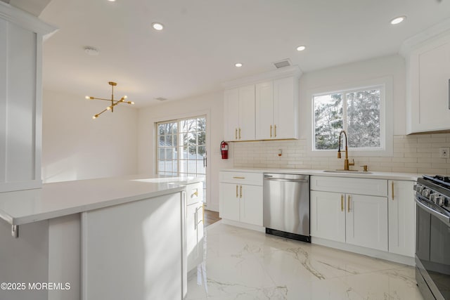 kitchen featuring decorative backsplash, recessed lighting, appliances with stainless steel finishes, and a sink