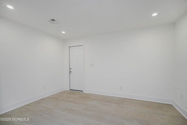 empty room with recessed lighting, visible vents, baseboards, and light wood finished floors