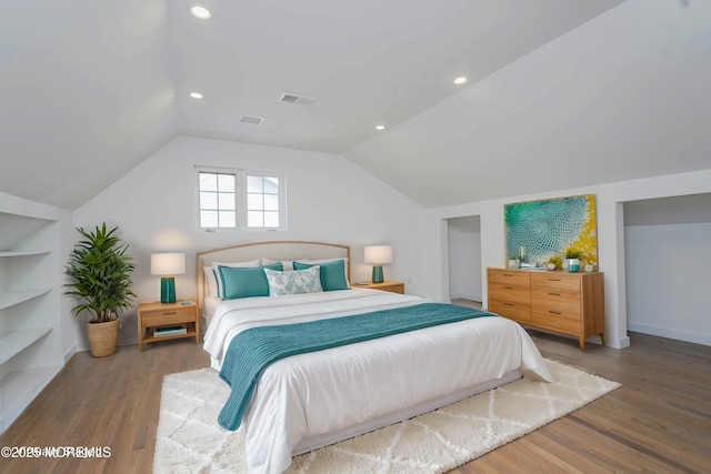 bedroom with vaulted ceiling, recessed lighting, wood finished floors, and visible vents