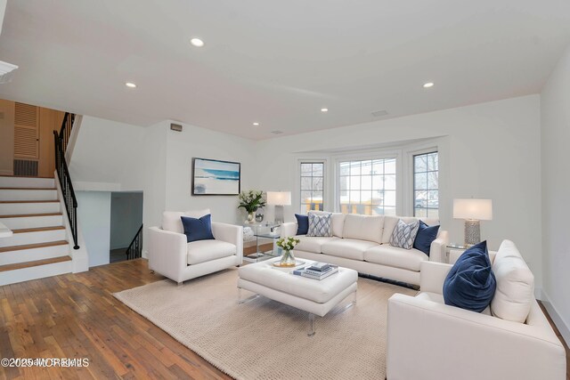 living area featuring stairs, recessed lighting, and wood finished floors