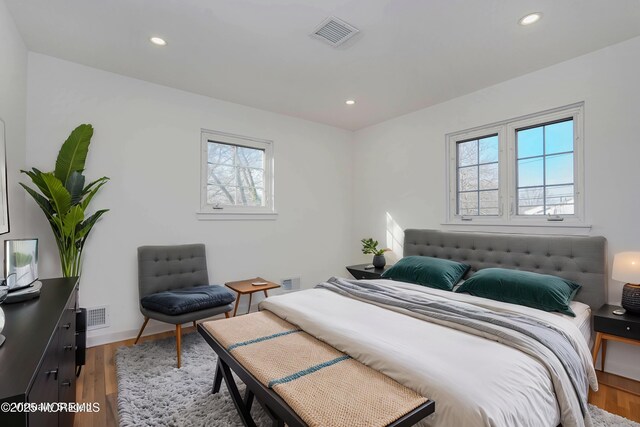 bedroom with recessed lighting, visible vents, baseboards, and light wood-style floors