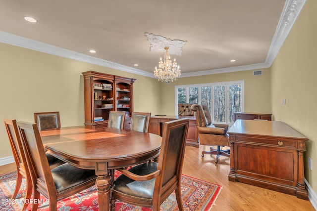 dining area with recessed lighting, light wood-type flooring, an inviting chandelier, and visible vents