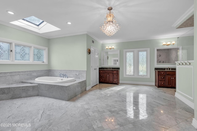 full bath with marble finish floor, two vanities, a garden tub, and ornamental molding