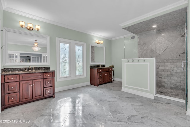 full bathroom featuring marble finish floor, a stall shower, a sink, crown molding, and baseboards