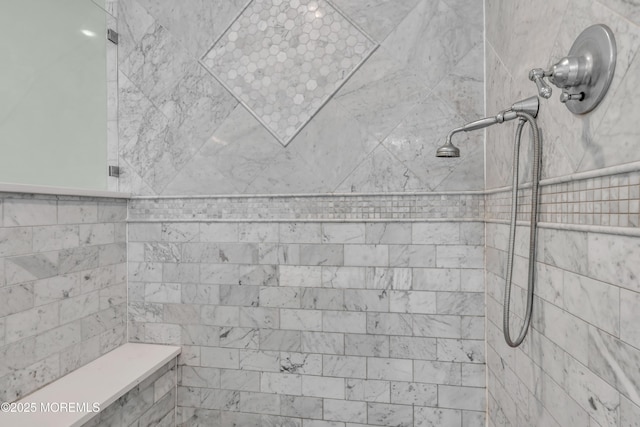 bathroom featuring tiled shower