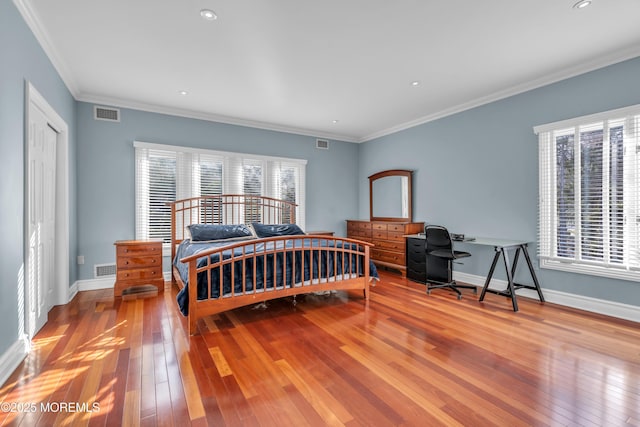 bedroom featuring baseboards, multiple windows, and wood-type flooring