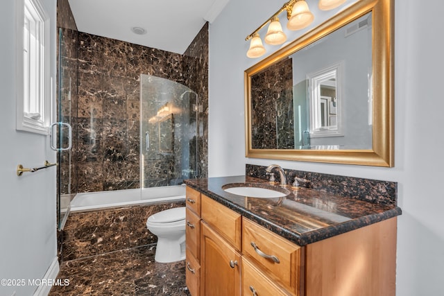 full bathroom with visible vents, toilet, marble finish floor, vanity, and tiled shower / bath