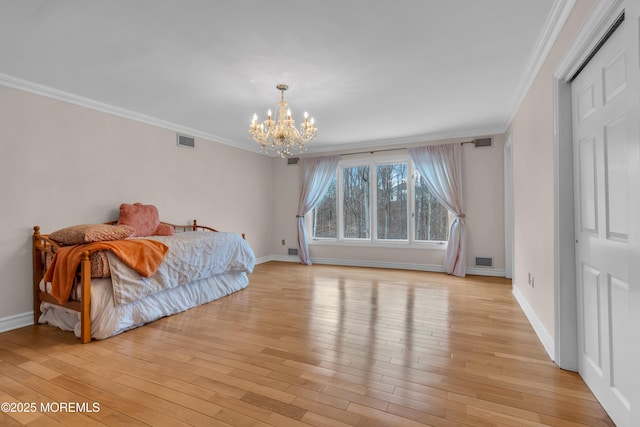 bedroom with light wood-type flooring, visible vents, and a notable chandelier