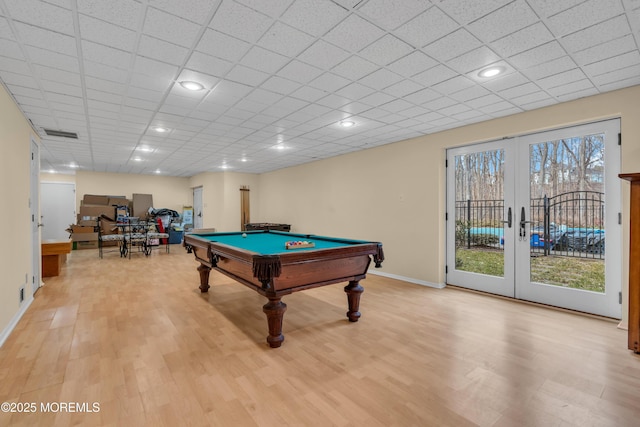 rec room featuring light wood-style flooring, french doors, visible vents, and baseboards