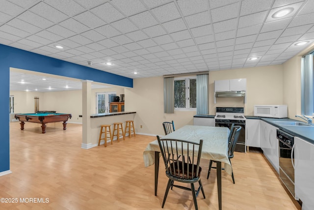 dining space with billiards, baseboards, light wood finished floors, recessed lighting, and a drop ceiling