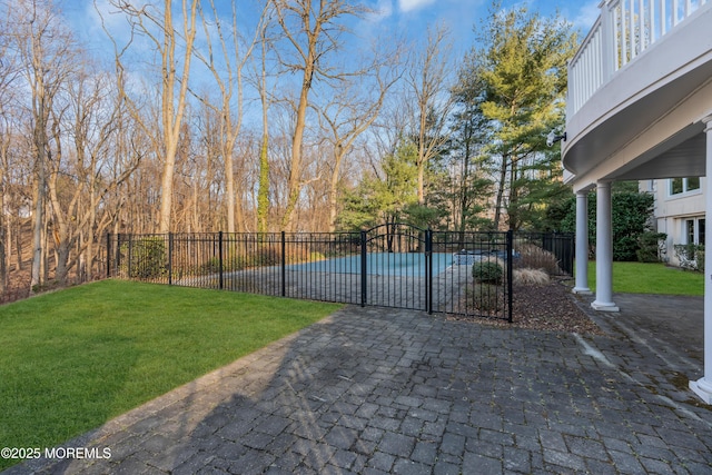 view of gate with a lawn and fence