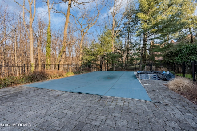 view of pool featuring a patio and fence