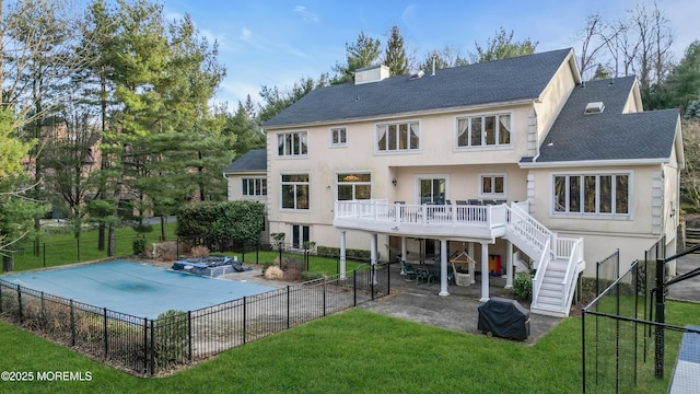 back of house with a wooden deck, stairs, stucco siding, a yard, and a patio area