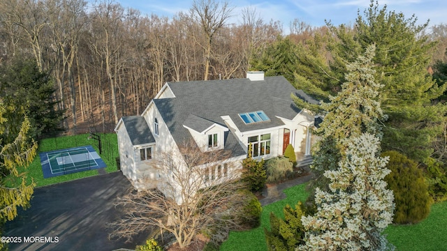 birds eye view of property with a wooded view