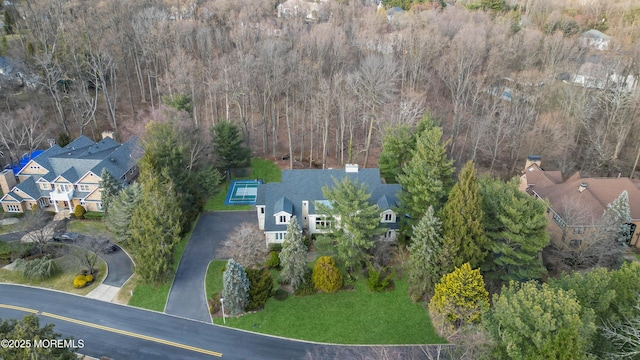 birds eye view of property with a view of trees