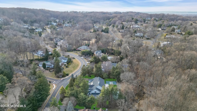 birds eye view of property featuring a view of trees