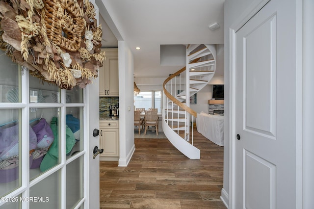 foyer featuring dark wood finished floors, recessed lighting, and stairs