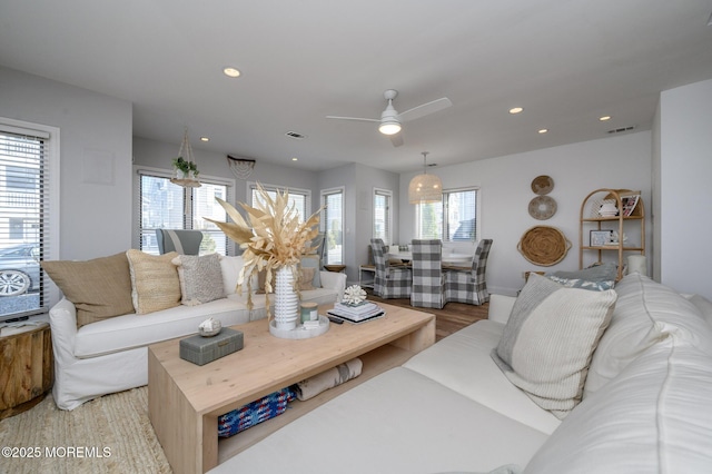 living room featuring recessed lighting, visible vents, light wood-style flooring, and ceiling fan