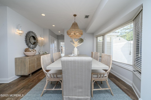 dining room featuring visible vents, dark wood-type flooring, and baseboards