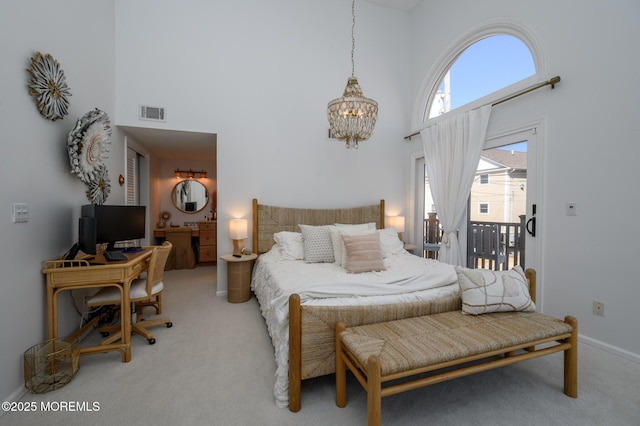 bedroom with light carpet, a high ceiling, and access to outside