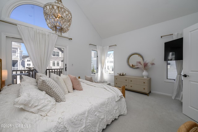 carpeted bedroom with high vaulted ceiling, baseboards, and access to outside