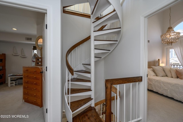 stairs featuring a notable chandelier, recessed lighting, visible vents, and carpet floors