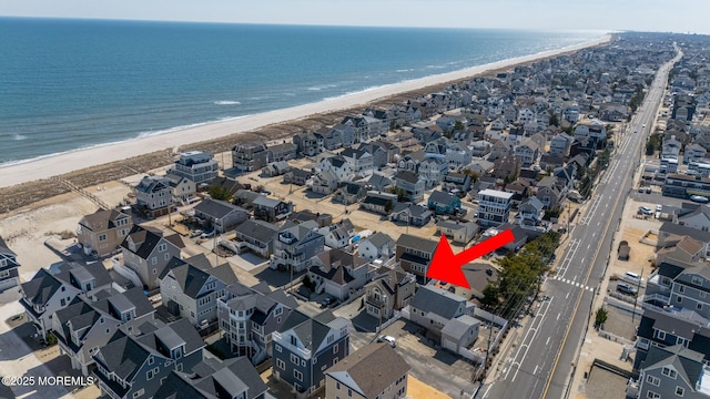 drone / aerial view featuring a view of the beach and a water view