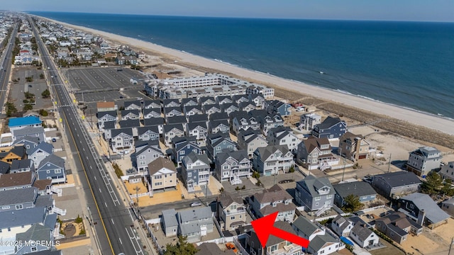 aerial view with a water view and a beach view