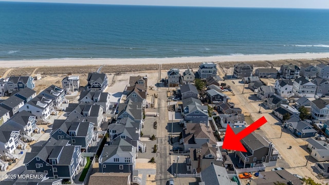 birds eye view of property with a residential view, a beach view, and a water view