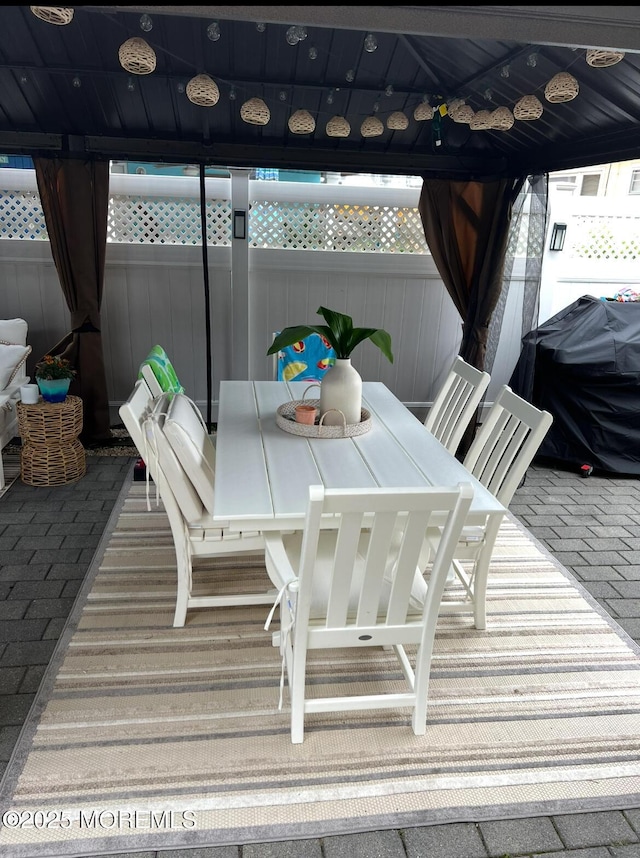 deck featuring a gazebo, outdoor dining space, and grilling area