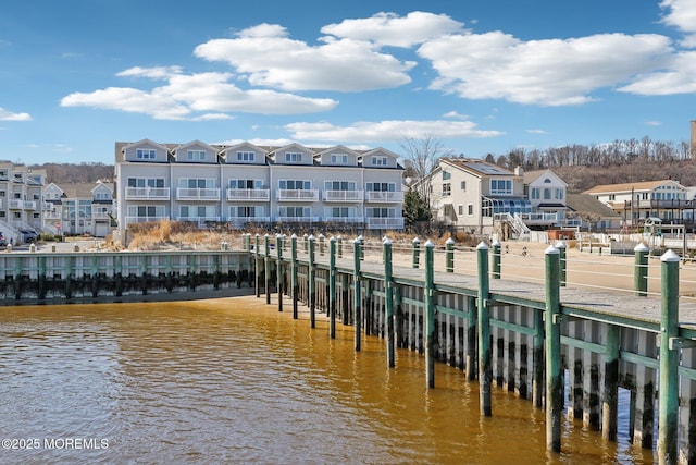 dock area featuring a residential view and a water view