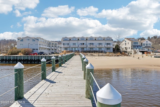 dock area with a residential view and a water view