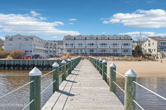 view of dock featuring a residential view and a water view