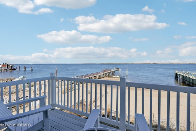 wooden deck featuring a dock and a water view