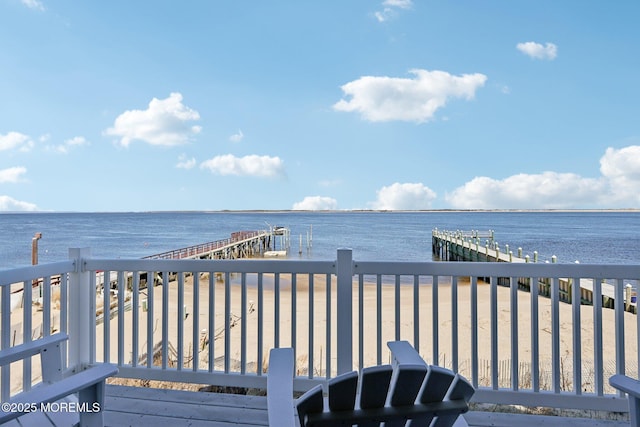 wooden terrace with a dock and a water view