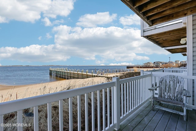 deck with a water view and a beach view