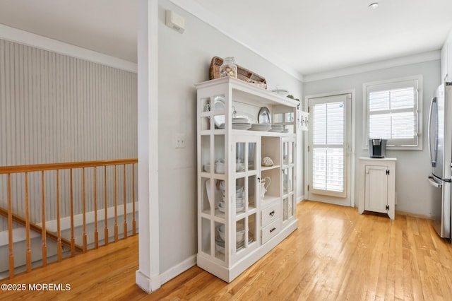 interior space with baseboards and light wood-style flooring