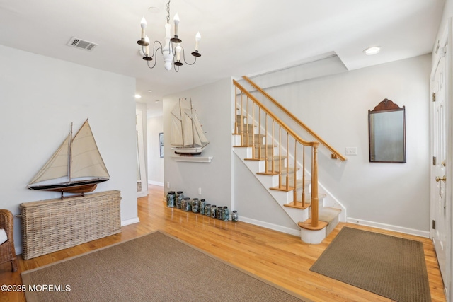 interior space featuring visible vents, baseboards, stairway, recessed lighting, and wood finished floors