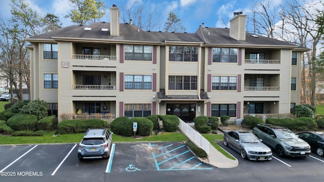 view of property featuring uncovered parking