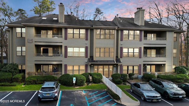 view of building exterior with uncovered parking