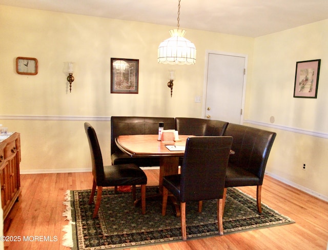 dining area featuring baseboards and wood finished floors