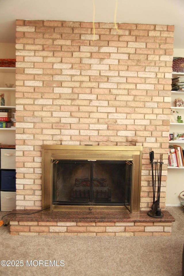 interior details with carpet and a fireplace