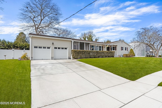 view of front of house with a garage, concrete driveway, a front yard, and fence