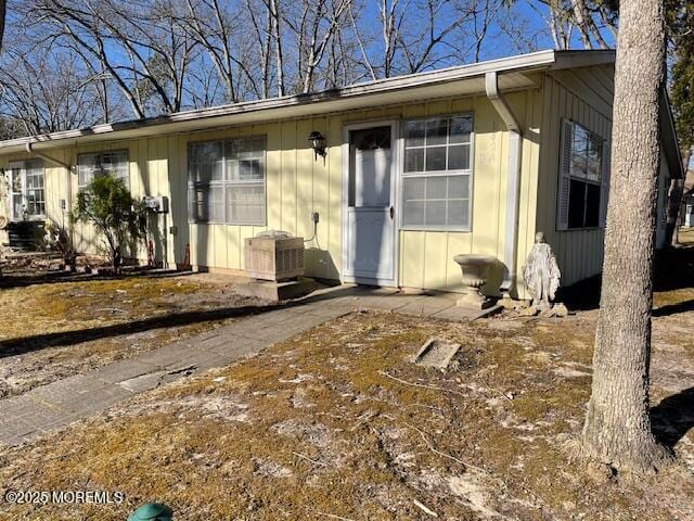 exterior space featuring central AC unit and board and batten siding